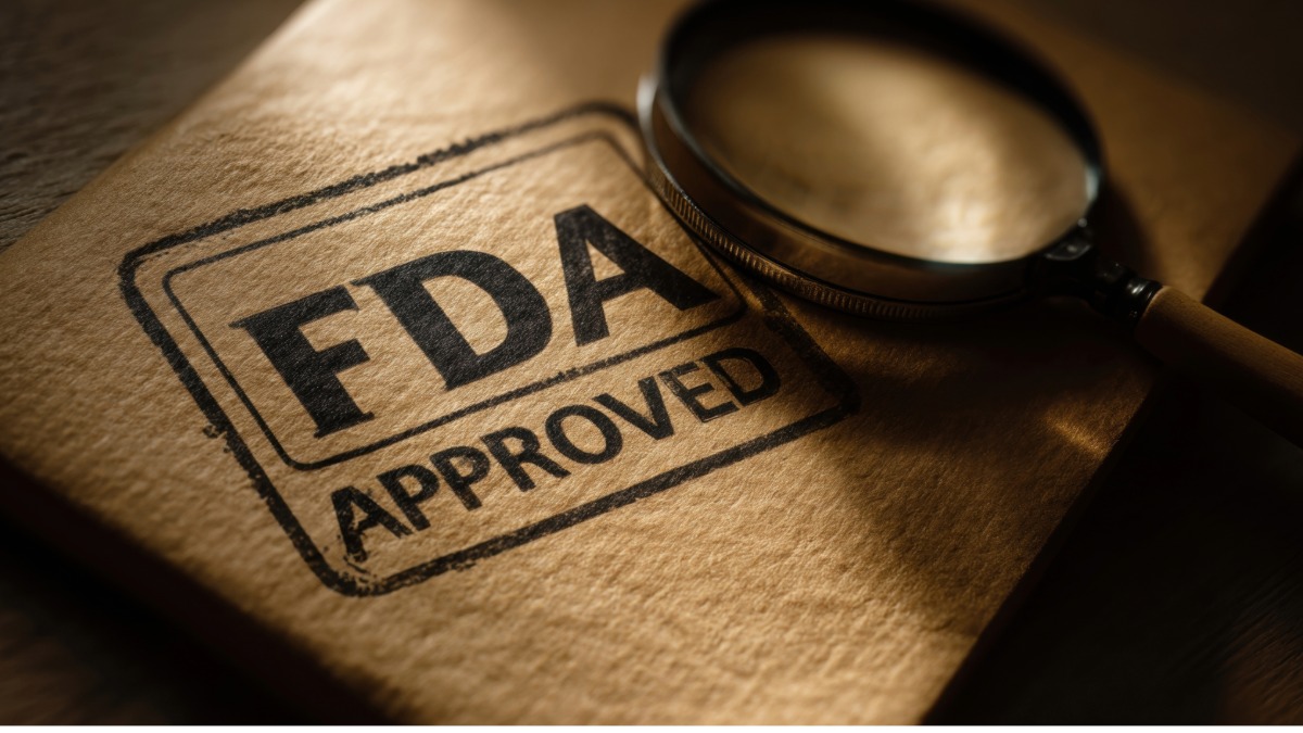 FDA Approved stamp with magnifying glass on dark wood desk with warm amber lighting