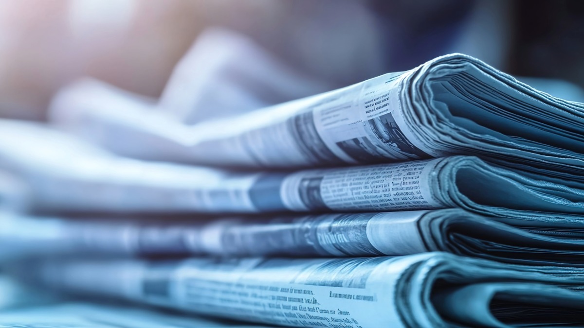 Stack of folded newspapers in close-up editorial photography showing print media
